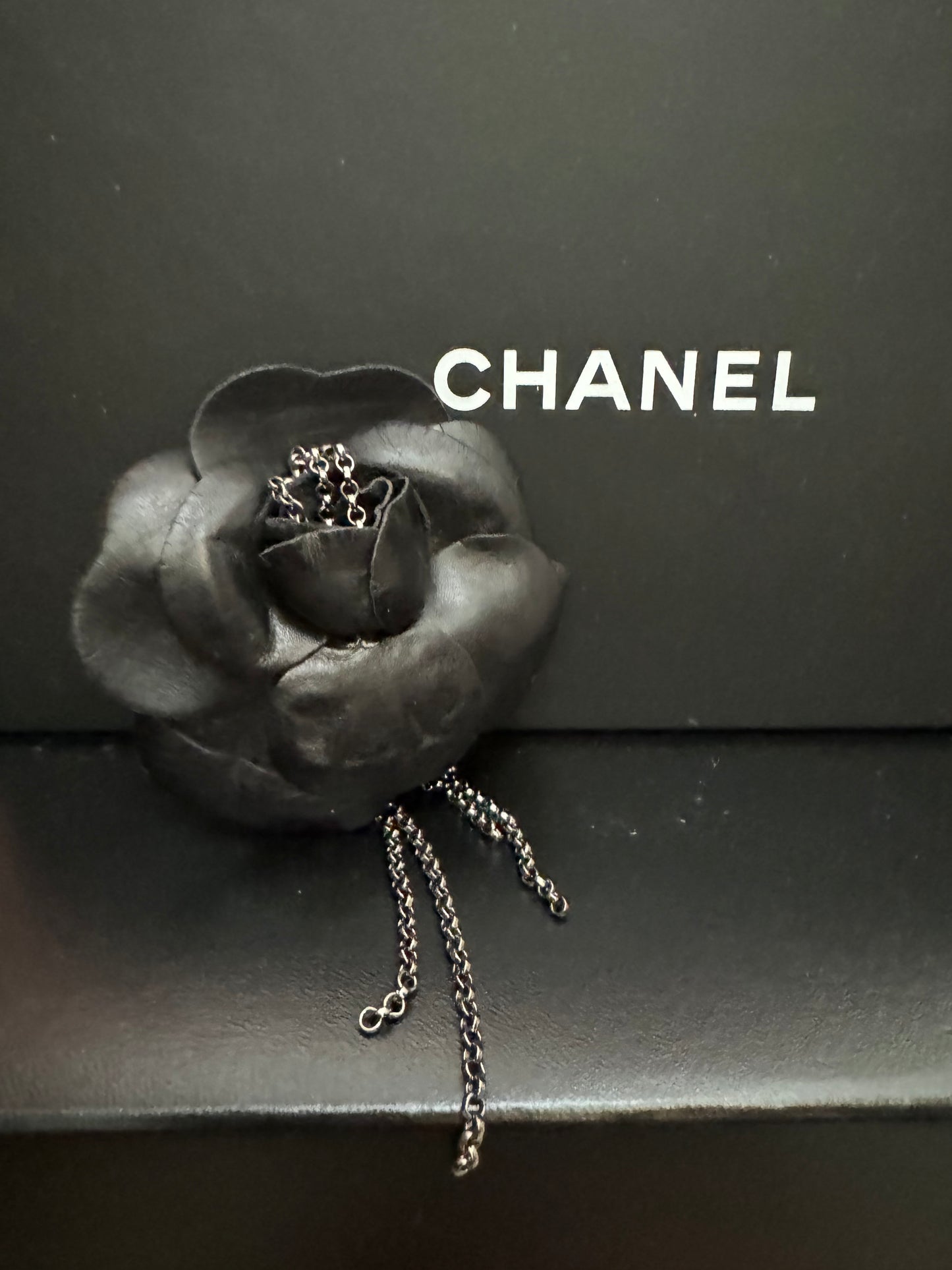 Authentic Chanel Lambskin Brooch with Chain Detail.