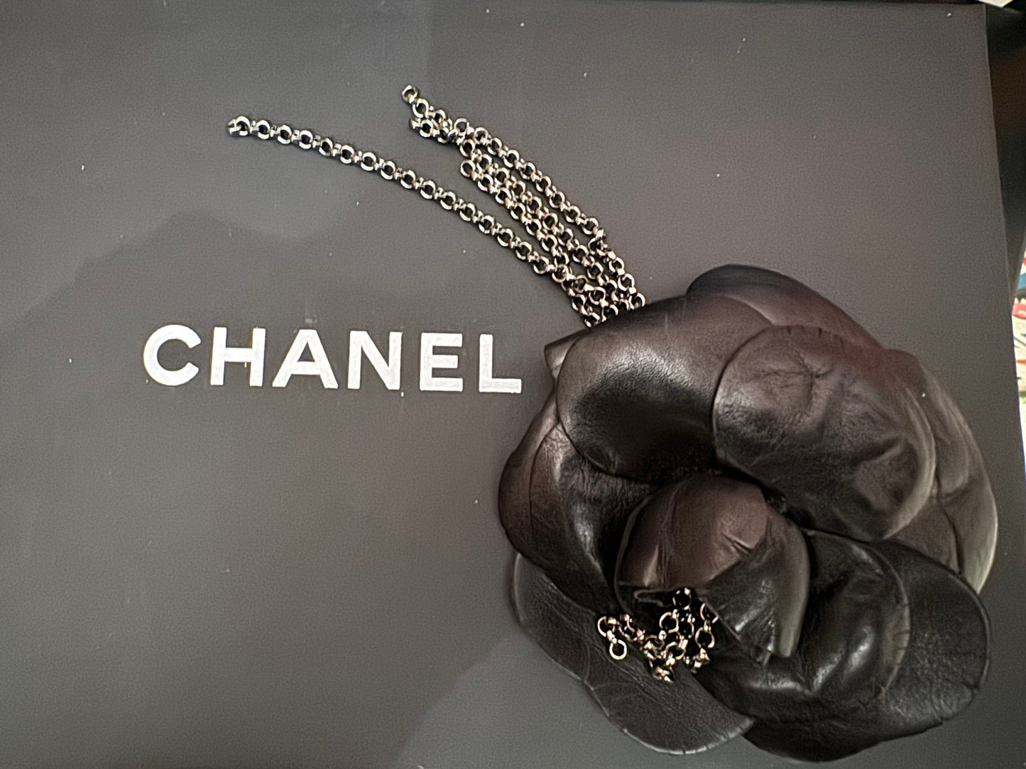 Authentic Chanel Lambskin Brooch with Chain Detail.