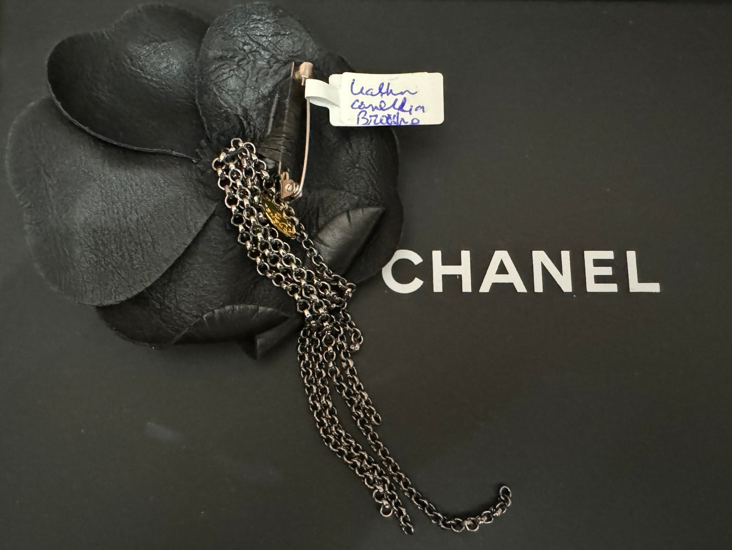 Authentic Chanel Lambskin Brooch with Chain Detail.